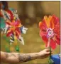  ?? JARED WICKERHAM THE NEW YORK TIMES ?? A flower bearing the name of Joyce Fienberg, one of the people killed at the Tree of Life synagogue, is placed during a ceremony in Schenley Park in Pittsburgh on Friday.