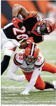  ?? JOHN GRIESHOP / GETTY IMAGES ?? Browns linebacker Joe Schobert tries to take down Bengals running back Joe Mixon last season in Cincinnati. Schobert rated poorly as a tackler, accounting for 24 of the team’s 169 missed tackles