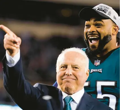 ?? MATT ROURKE/AP ?? Eagles owner Jeffrey Lurie, left, gestures while standing on stage with defensive end Brandon Graham after the NFC Championsh­ip game win over the San Francisco 49ers.