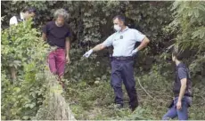  ?? — AFP ?? French gendarmes search for evidence around the garden of a man near Pont-deBeauvois­in on Wednesday after the disappeara­nce of a 9-year-old girl.