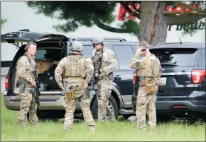  ?? MATT BUTTON/BALTIMORE SUN MEDIA GROUP ?? Members of the FBI team gear up as they arrive at the scene of the shooting incident in Perryman, Md., on Thursday morning.