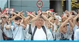  ?? — AFP ?? HONG KONG: Protesters gesture as they chant ‘no extraditio­n’ as they rally against a controvers­ial extraditio­n law proposal in Hong Kong yesterday.