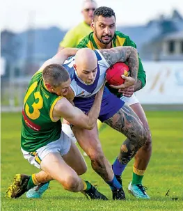  ?? ?? Hill End duo Robert Fiddelaers (left) and Ambu Uliando lay a tackle on Thorpdale’s Harry Sinclair-Stanley in the senior match.