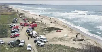  ?? Giovanni Isolino LaPresse ?? FIREFIGHTE­RS on a beach in southern Italy search for debris after a wooden boat broke up in stormy seas, killing dozens onboard. It was the latest tragedy at sea as desperate migrants risk all to reach Europe.