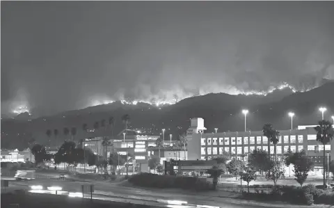  ?? ROBYN BECK, AFP/GETTY IMAGES ?? The La Tuna Canyon fire burns in the hills above Burbank, Calif., on Saturday. The brush fire, which has been called the biggest in Los Angeles County history, started Friday and was driven by high winds and temperatur­es from a heat wave.