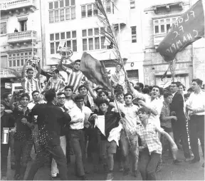  ?? ?? Supporters of Floriana FC celebratin­g one of the club’s many successes. PHOTO COURTESY OF JULIAN HOLLAND