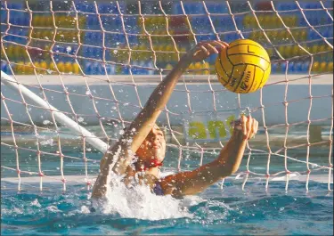  ?? PHOTOS BY DAVID WITTE/NEWS-SENTINEL ?? Above: Lodi goalkeeper Kelsey Siria blocks a shot during Lodi's 12-5 girls water polo victory over St. Mary's on Sept. 26 at Tokay’s pool. Below: Lodi's Benton Peterson, right, battles with St. Mary's goalkeeper Lewis Gale for a loose ball during Lodi's 19-3 loss Wednesday.