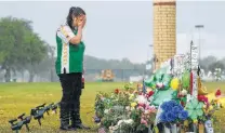  ?? Godofredo A. Vasquez / Houston Chronicle ?? Sierra Dean, 16, grieves while visiting a memorial for her best friend, Kimberly Vaughan, who was killed in the shootings at Santa Fe High School.