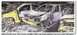  ??  ?? Charred cars are seen at the site of a bombing at an auto dealership in Baghdad. The blast killed 55 people.