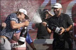  ?? LYNNE SLADKY — THE ASSOCIATED PRESS ?? Cameron Smith, left, and Dustin Johnson celebrate after the final round of the LIV Golf Team Championsh­ip at Trump National Doral Golf Club on Sunday. Johnson’s 4 Aces GC team won the title.