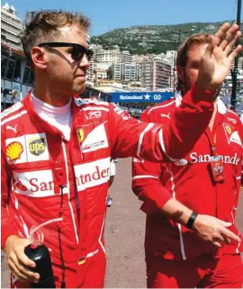  ??  ?? Ferrari driver Sebastian Vettel of Germany waves to the fans from the paddock Photo: AP