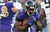  ?? GAIL BURTON — THE ASSOCIATED PRESS ?? FILE - In this Sunday, Nov. 25, 2018, file photo, Baltimore Ravens running back Gus Edwards, center, carries the ball in the second half of an NFL football game against the Oakland Raiders in Baltimore.