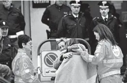  ?? BOBO ANTIC/AP ?? Relatives and friends comfort each other Saturday outside the morgue in Corinaldo, a town in central Italy. Five teens, three of whom were girls, and a mother died.