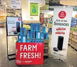  ?? Joseph Pisani Associated Press ?? AFTER TAKING over Whole Foods this summer, Amazon slashed prices, added its logo on signs and set up a stand of “farm fresh” Amazon Echo virtual assistant devices by store entrances. Above, a Whole Foods store in New York in August.