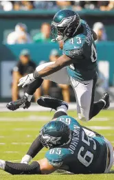  ?? MICHAEL PEREZ/AP ?? Darren Sproles, leaping over tackle Lane Johnson, rushed for a game-high 47 yards as his Eagles defeated the Redskins on Sunday.