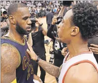  ?? CP PHOTO ?? Toronto Raptors guard DeMar DeRozan (right) congratula­tes Cleveland Cavaliers forward LeBron James at the end of the game following the Raptors’ loss to the Cavalier during NBA playoff action in Toronto on Sunday.