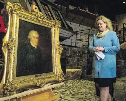 ??  ?? This portrait of Capt. George Vancouver is revealed in a ceremony with Janice Charette, Canadian high commission­er to the U.K., beside the replica of his ship HMS Discovery at the Royal B.C. Museum on Tuesday.