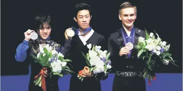  ?? — Reuters photo ?? Nathan Chen (centre) of the US poses with the gold medal as Japan’s Shoma Uno and Russia’s Mikhail Kolyada (right) pose with their silver and bronze medals after the Men’s Free Skating.