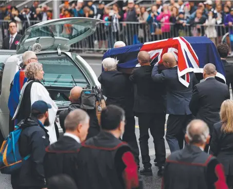  ??  ?? The coffin of Lou Richards is carried during the former Collingwoo­d legend’s state funeral yesterday Picture: ADAM TRAFFORD ASHLEY ARGOON