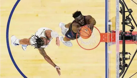  ?? Matt Slocum/Associated Press ?? UConn’s Adama Sanogo, right, goes up for a dunk against Villanova’s Brandon Slater on March 4.