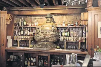  ?? [STEVE STEPHENS/DISPATCH PHOTOS] ?? A happy Buddha watches over the bar at Father John’s Heavenly Devilish Brewing Company in Bryan.