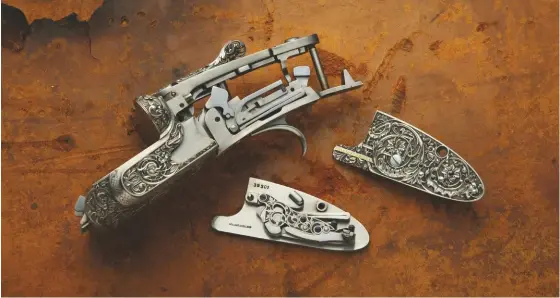  ??  ?? the action body – one of only a few major parts retained from the original CAD concept – and its two back-action sidelocks. the guns have deeply carved engraving on coin-finished actions by the specialist Italian house Creative Arts