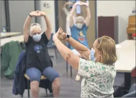  ?? BEN HASTY — READING EAGLE ?? Barbara Mills, front, Body Recall instructor, leads the exercise class. Participat­ing are, from left, Elaine Hartman, and Peg Wrede, both of Reading.