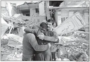  ?? AP/VAHID SALEMI ?? Earthquake survivors mourn Wednesday outside destroyed homes in Sarpol-e-Zahab in western Iran.