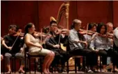  ?? HONG XIAO / CHINA DAILY ?? Yu Renchao (third from left), from Shanghai, at a rehearsal with the New York Philharmon­ic on Monday at Lincoln Center.
