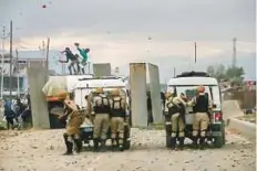  ?? AP ?? Protesters throw stones at police men during a protest in outskirts of Srinagar on Friday.