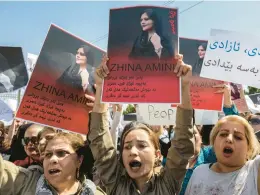  ?? SAFIN HAMED/GETTY-AFP ?? Women hold up images of Mahsa Amini, who died in Iranian custody, during a demonstrat­ion Saturday in Arbil, the capital of Iraq’s autonomous Kurdistan region.