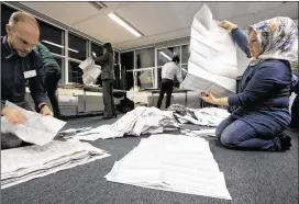  ?? PETER DEJONG / ASSOCIATED PRESS ?? Paper ballots are sorted and hand-counted Wednesday at the mayor’s office in The Hague. Voting results appeared to show a nation that agreed it disliked the status quo but was divided about an alternativ­e direction.