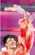  ?? —REUTERS ?? JURY’S CHOICE Nemo representi­ng Switzerlan­d holds the Eurovision sculpture after winning the 2024 Eurovision Song Contest in Sweden on May 11.