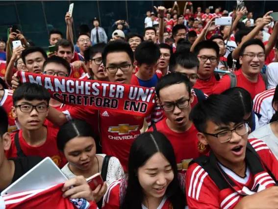  ??  ?? Manchester United fans in China wait for their heroes (Getty)