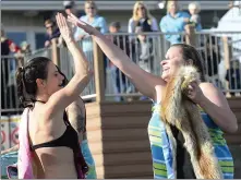 ??  ?? Right:
Kate Antonini and Natalia Shorten, both of Novato, highfive after their jump.