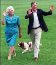  ?? THE ASSOCIATED PRESS ?? In this Aug. 24, 1992, file photo, President George H.W. Bush and first lady Barbara Bush walk with their dog Millie across the South Lawn as they return to the White House.