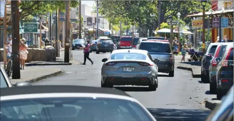  ?? The Maui News / MATTHEW THAYER photos ?? The sidewalks along Lahaina’s Front Street are busy with visitors Wednesday afternoon. As tourism returns and Maui County has nearly matched Oahu in visitor arrivals, the county’s hotels lead the state in room revenue and average daily rates, though occupancy continues to be far below what it was last year.