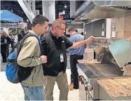  ?? [PHOTO PROVIDED] ?? Dan Reeves, right, owner of Landmark Fine Homes, and employee Jason Underhill look at new products on display at the 2016 Internatio­nal Builders' Show in Las Vegas.