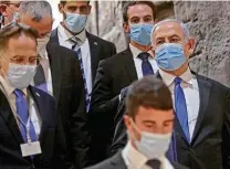  ?? Pool / AFP via Getty Images ?? Israel Prime Minister Benjamin Netanyahu, right, arrives May 17 for the swearing-in ceremony at Israel’s parliament.