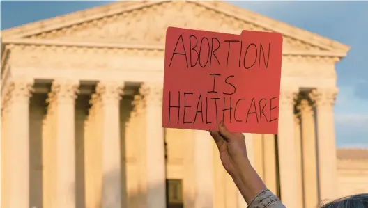  ?? ALEX BRANDON/AP ?? Later this year, the U.S. Supreme Court may overturn the 1973 decision that legalized abortion nationwide. Above, a person holds a sign on Wednesday in Washington, D.C.