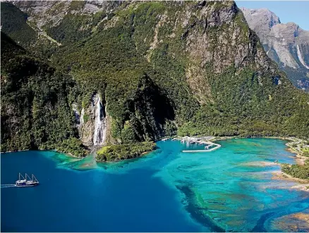  ?? NICOLAS CUERVO/500PX ?? A boat anchors beside a waterfall in Milford Sound.