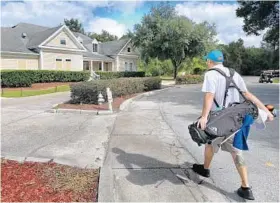  ?? JOE BURBANK/STAFF PHOTOGRAPH­ER ?? Golfer Jesse Daschbach arrives at the clubhouse at the Twin Rivers Golf Club in Oviedo on Tuesday. Owners recently revised their proposal and again are asking for city approvals.