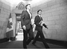  ??  ?? Canada’s Prime Minister Justin Trudeau (left) and Finance Minister Bill Morneau walk from Trudeau’s office to the House of Commons to deliver the budget on Parliament Hill in Ottawa, Ontario, Canada. — Reuters photo