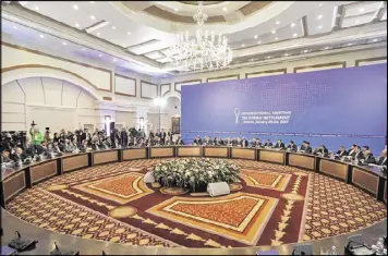  ?? SERGEI GRITS / ASSOCIATED PRE SS ?? Delegation­s from Russia, Iran and Turkey hold talks on the Syrian peace process at a hotel in Astana, Kazakhstan, on Monday. The talks were focused on improving a Dec. 30 cease-fire, not finding a political solution to the Syrian war.