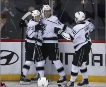  ?? JOHN MUNSON — THE ASSOCIATED PRESS ?? Kings forward Quinton Byfield, middle, celebrates his goal with teammates Trevor Moore, left, and Pierre-Luc Dubois in Thursday’s win