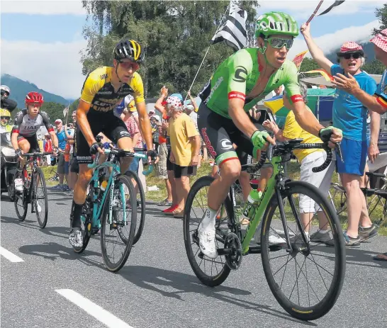  ?? Picture / AP ?? George Bennett ( yellow sleeves) and Rigoberto Uran ( in green) were both penalised 20 seconds yesterday for accepting water from Tour de France fans.