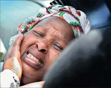  ?? PICTURE: NOKUTHULA MBATHA ?? OVERCOME BY GRIEF: Eunice Melaphi weeps after her husband Vuyisile Melaphi was shot in Windmill Park, Boksburg, in an attack involving rival taxi associatio­ns.