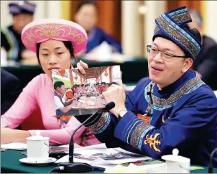  ?? WU ZHIYI / CHINA DAILY ?? Huang Bingfeng, an NPC deputy and head of Huanjiang Maonan autonomous county in the Guangxi Zhuang autonomous region, makes a presentati­on on poverty relief for relocated farmers during a panel discussion attended by Premier Li Keqiang in Beijing on Wednesday.