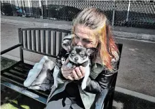  ?? RICHARD VOGEL THE ASSOCIATED PRESS ?? Rachel Niebur kisses her dog, Petey, at a small dog park in the Venice section of Los Angeles. “She needs me. She gives me my focus,” Niebur says of her chihuahua cross.