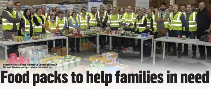  ??  ?? The staff of Kersia help Wexford Co Council chairman Michael Sheehan pack parcels for the food drive.